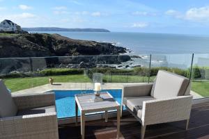a patio with a view of the ocean at Watersmeet Hotel in Woolacombe