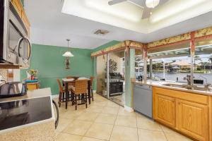 a kitchen with a table and a dining room at Villa Catalina Isles - Holidays in Paradise in Cape Coral