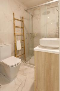 a bathroom with a toilet and a sink and a shower at Casa dos Relevos - Centro Histórico de Santarém in Santarém