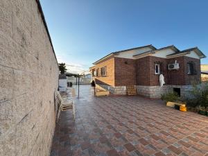 a brick building with a patio and a brick wall at Magnífico chalet con piscina privada y vistas impresionantes in Aldea del Fresno