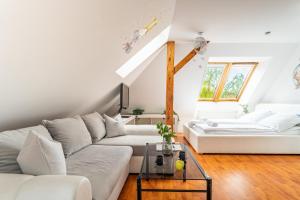 a living room with two white couches and a table at RJ Apartments Chopina in Sopot
