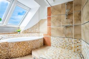 a bathroom with a tub and a window at RJ Apartments Chopina in Sopot +34 photos