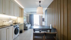 a kitchen with a table and a dining room at Marina House MUAYTHAI Ta-iad Phuket in Chalong 