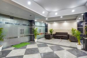 a lobby with a waiting room with plants at Hotel Durbar By Vardaan Residency in Gurgaon