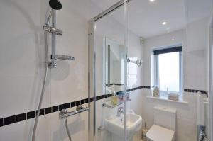a bathroom with a shower and a toilet and a sink at Foxwood in Kenwyn +23 photos