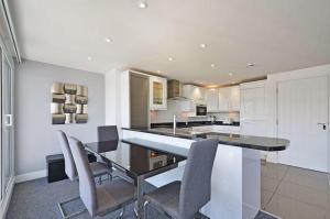 a kitchen with a dining table and chairs at Foxwood in Kenwyn