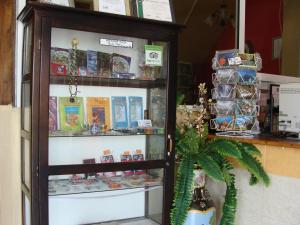 a display case in a store filled with lots of items at Mirador Hotel in Corozal