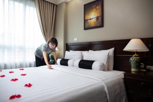 Voodi või voodid majutusasutuse Lotusama Central Hanoi Hotel toas