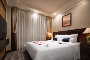 Voodi või voodid majutusasutuse Lotusama Central Hanoi Hotel toas