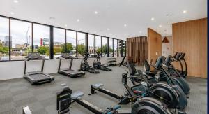 a gym with a bunch of bikes in a room at Brand new sunny apartment comfy with views - 2 Bedrooms 2 Baths 2 Parking Gym & Pool in Canberra