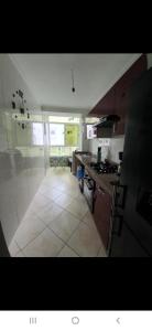 a kitchen with a stoveasteryasteryasteryasteryasteryasteryasteryasteryasteryasteryastery at Appartement à côté la plage in Oulad Akkou