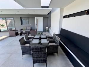 a dining room with a table and chairs at Elite Water House in Patra
