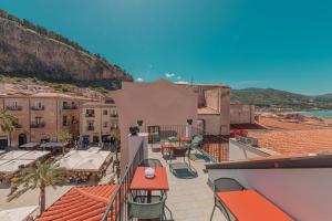 a view of a city from the balcony of a building at Palazzo Villelmi in Cefalù +65 photos