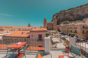 a view of a city from a balcony with a building at Palazzo Villelmi in Cefalù