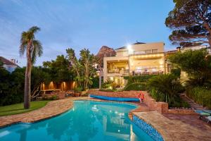 a house with a swimming pool in front of a house at 42 On Strathmore in Cape Town