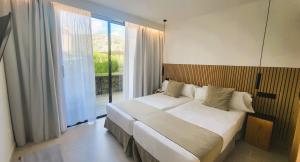A bed or beds in a room at Hotel Bahia Pollensa