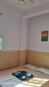 a bed with a blanket on it in a room at Green male rooms in Bhopal
