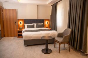 a hotel room with a bed and a chair at Rest by Dedeman Elbistan in Elbistan +38 photos