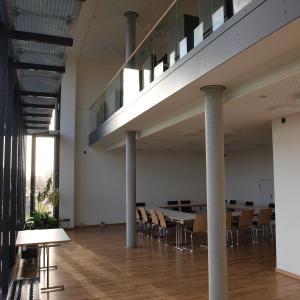 ハンブルクにあるユーゲンデルベルグ ハンブルク ホルナー レンバーンのテーブルと椅子付きの広い客室です。