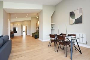 a dining room and living room with a table and chairs at Ground Floor Barn with Hot Tub, Dog Friendly, Sleeps up to 8 close to Monmouth, Ross on Wye, Hay on Wye and Hereford! in Broad Oak
