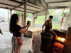 a woman is taking a picture of a man at Dan Sinh Homestay in Can Tho