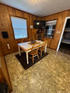 a dining room with a table and chairs at The Miss Ella Houseboat 