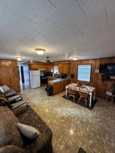 a living room with a couch and a table at The Miss Ella Houseboat 