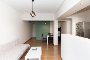 a living room with a couch and a table at The Glyfada Hideaway in Athens