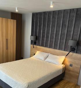 a bedroom with a large bed with two pillows at Pokoje Gościnne Lidka in Dziwnów