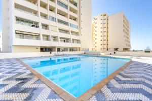 ein Schwimmbad vor einem Gebäude in der Unterkunft Holiday Praia da Rocha in Strand Praia da Rocha