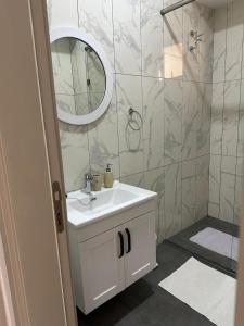 a bathroom with a white sink and a mirror at Aqua marine in Mombasa