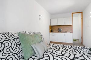 a living room with a bed and a kitchen at seenahes chices Apartment in Öhningen in Öhningen +10 photos