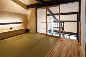 an empty room with a staircase and a window at 町宿 紬 in Obama