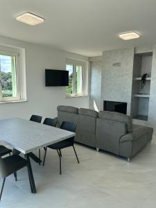 a living room with a couch and a table at Villa Colle dei Pini in Cupra Marittima