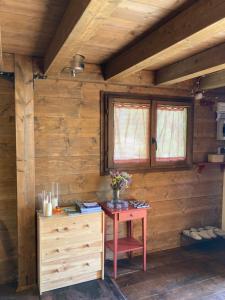 a wooden room with a table with flowers on it at La BAITA in Roccabruna