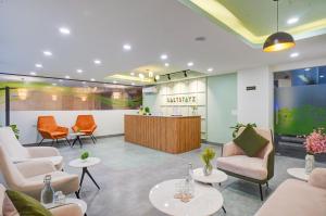 a waiting room with chairs and a counter at Saltstayz Premier - Arjun Marg in Gurgaon