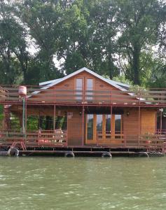a house on a boat in the water at Holiday Home Sava River House in Belgrade