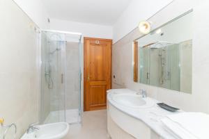 a bathroom with a sink and a shower and a mirror at San Teodoro Villa Nina Costa Caddu in San Teodoro +22 photos