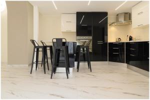 a kitchen with black chairs and a table in a room at Piave X Design Loft Quadrilatero WiFi AC in Turin +25 photos