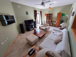 a living room with a couch and a tv at Grand & Cozy apartment on great location, central in Is-Swieqi