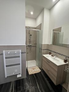 a bathroom with a sink and a shower at Il tulipano in Ventimiglia +21 photos