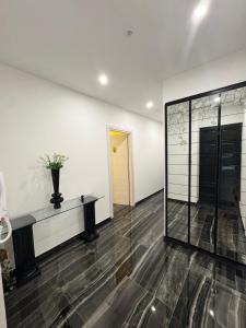 an empty room with a glass wall and a table at Il tulipano in Ventimiglia +21 photos