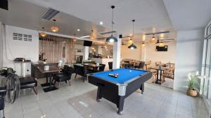 a room with a pool table in a restaurant at Desa Phuket in Phuket Town