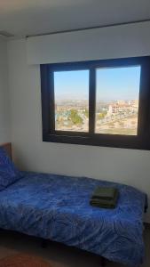 a bedroom with a bed and a large window at Costa Blanca Suit in Arenales del Sol