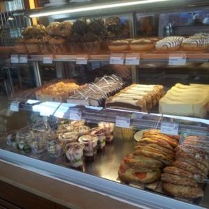 a display case in a bakery with many different pastries at Hotel Neuer Karlshof in Baden-Baden