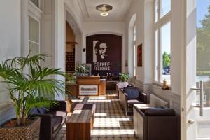 a lobby with couches and chairs and a table at Hotel Neuer Karlshof in Baden-Baden