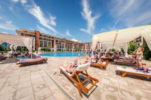 un grupo de personas sentadas en sillones en un complejo en Private Apartment 171 in Prestige Fort Beach Hotel, en Sveti Vlas