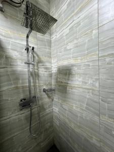 a bathroom with a shower with a shower head at Sea View Apartment in Colombo +21 photos