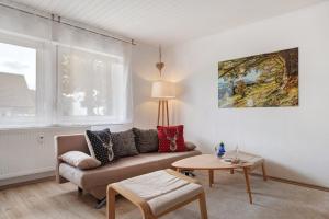 a living room with a couch and a table at Ferienwohnung am Schwellenweiher in Feldberg