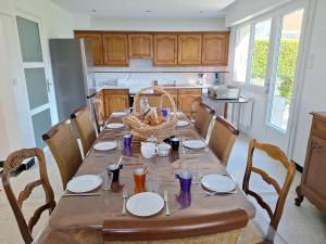 a kitchen with a table with plates and a basket on it at Ô Charme de St Ô 4 étoiles in Saint-Omer